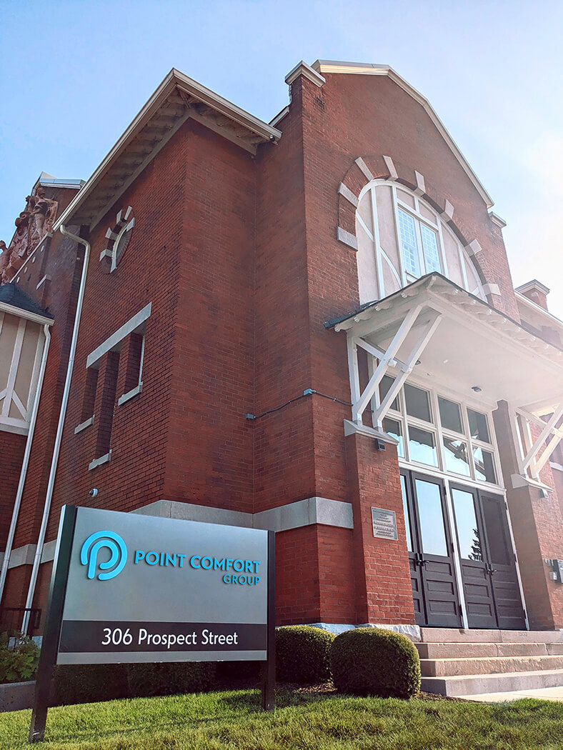 Point Comfort Group building front with close-up on sign